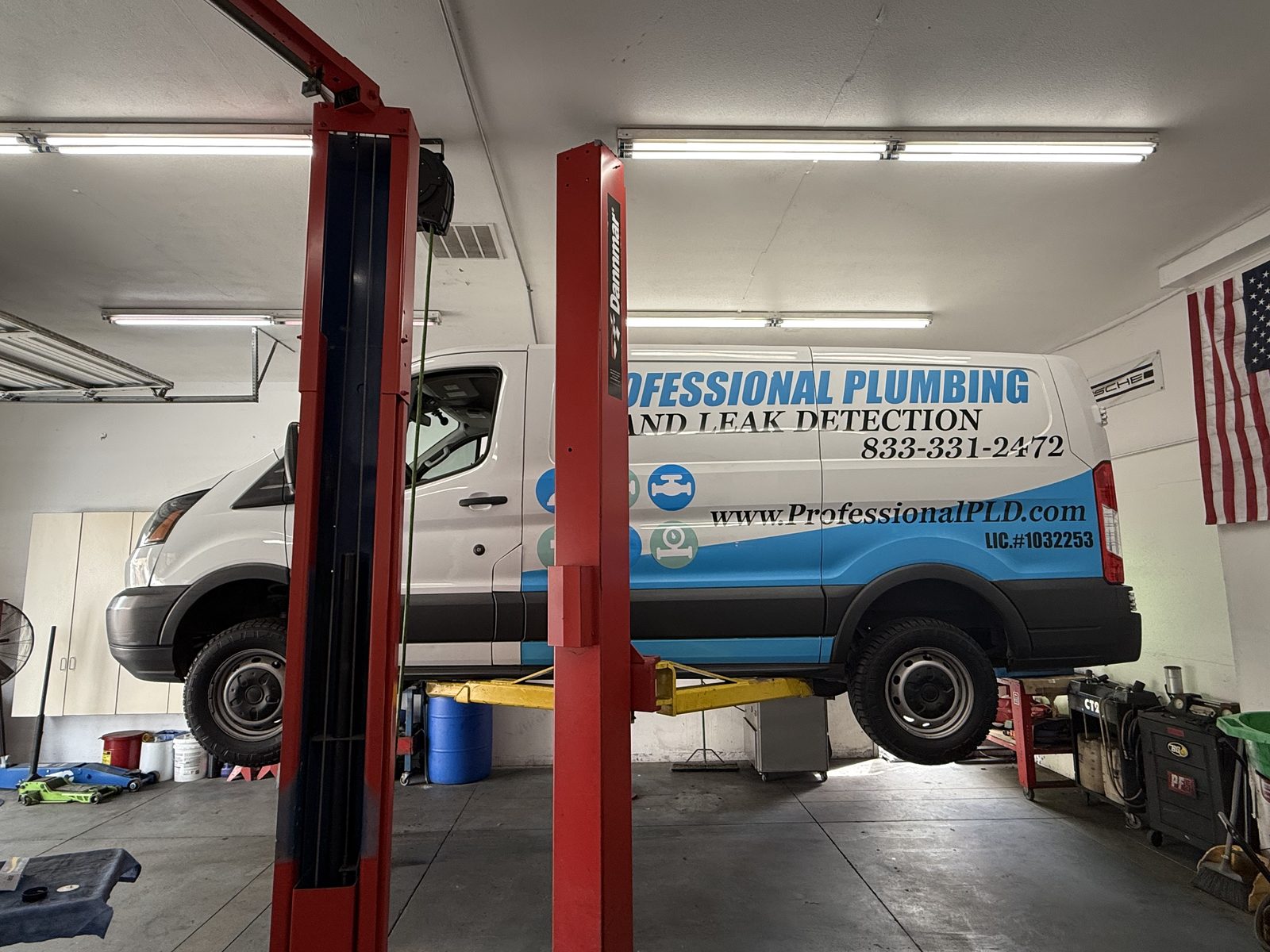 Plumbing company van up on the lift